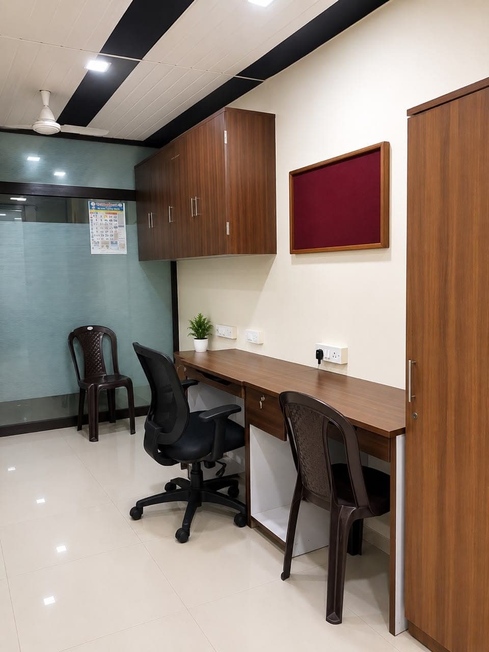 The separate study and office room for boys, with a long desk, chairs and a notice board