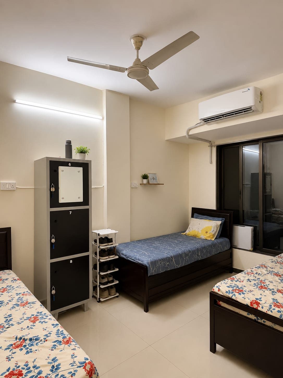 Room with a personal lockable cupboard for each resident, AC and a ceiling fan