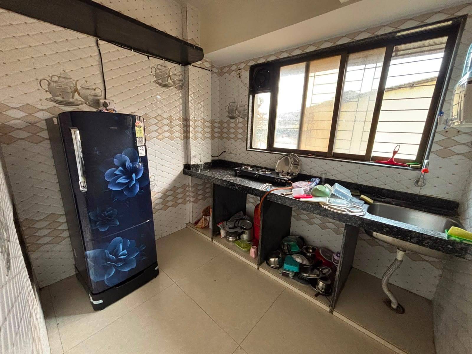 Kitchen with a gas stove, sink and refrigerator, where residents can cook their own food